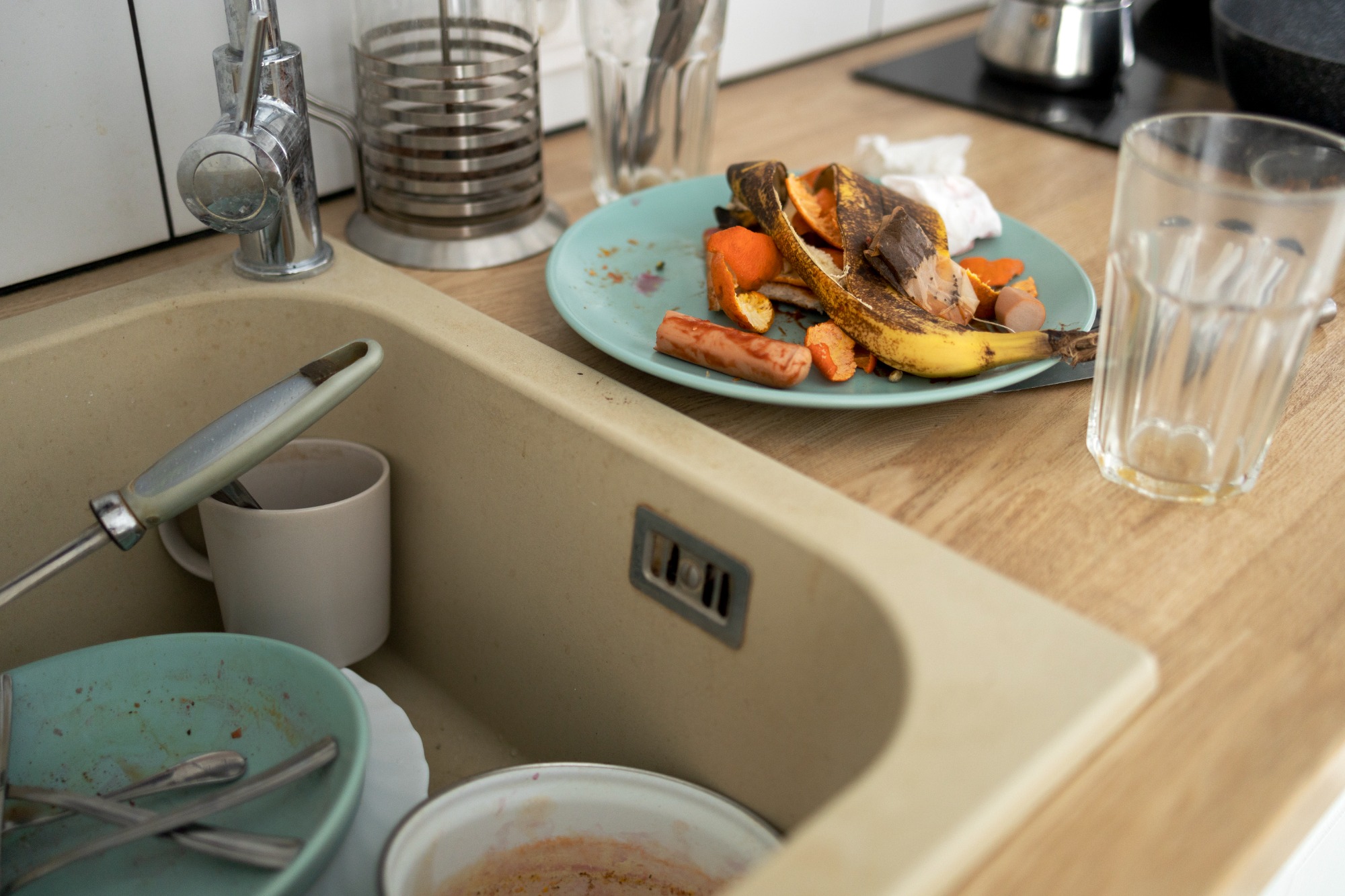 dirty kitchen sink filled with dishes