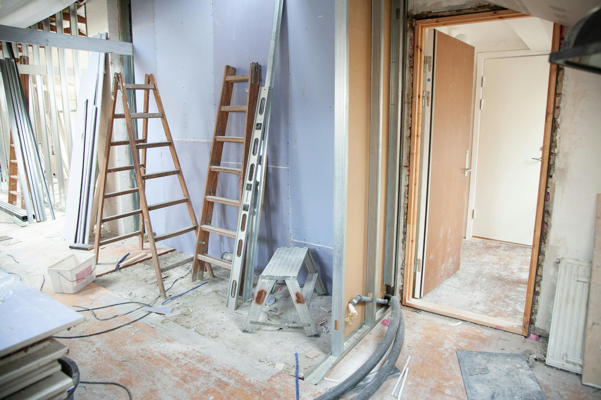 Messy interior home reno, new flooring & drywall. lots of sawdut and mess.
