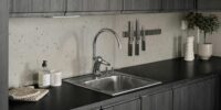 beautiful kitchen with stainless steel sink and faucets