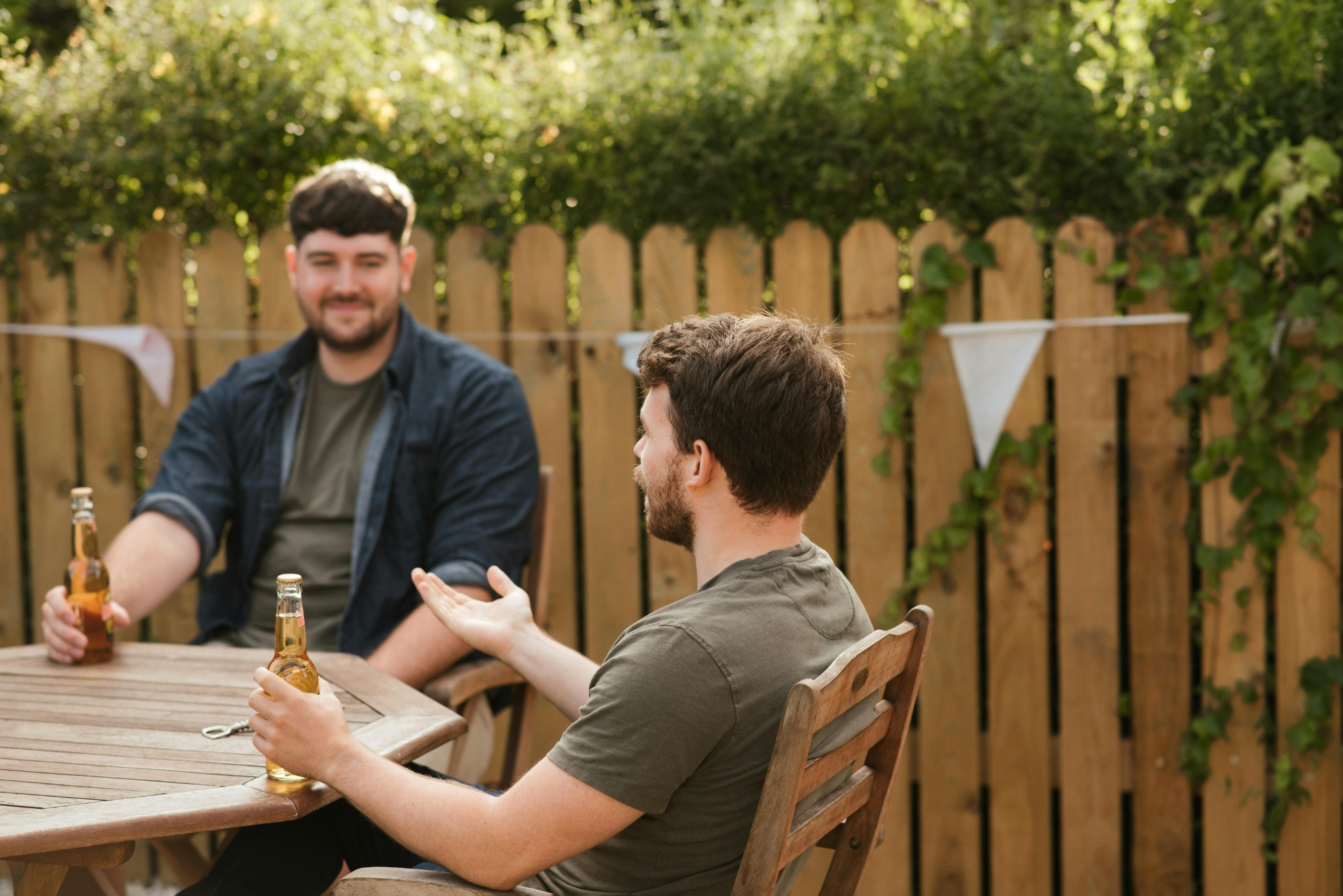 Neighbors enjoying a BBQ in their backyard.