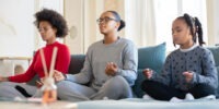 three woman sitting in yoga poses relaxing - tidy bird cleaning burlington, on just cleaned their home
