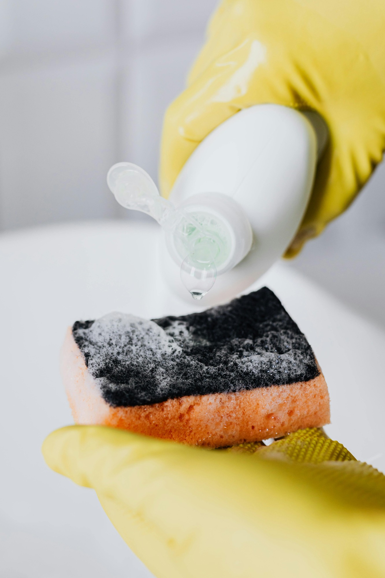 cleaning supplies, house cleaning person cleaning kitchen, close up Tidybirdcleaning