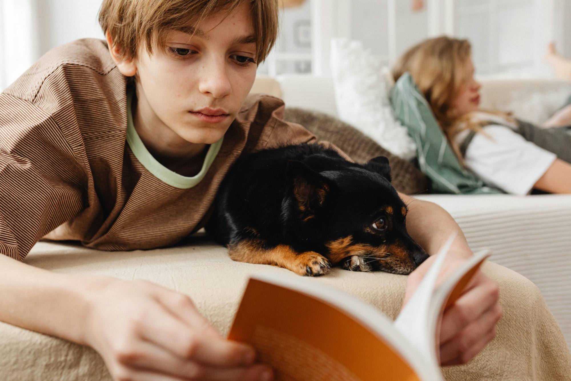 boy reading with his cute little dog
