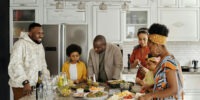 Happy Black family making dinner in a clean kitchen