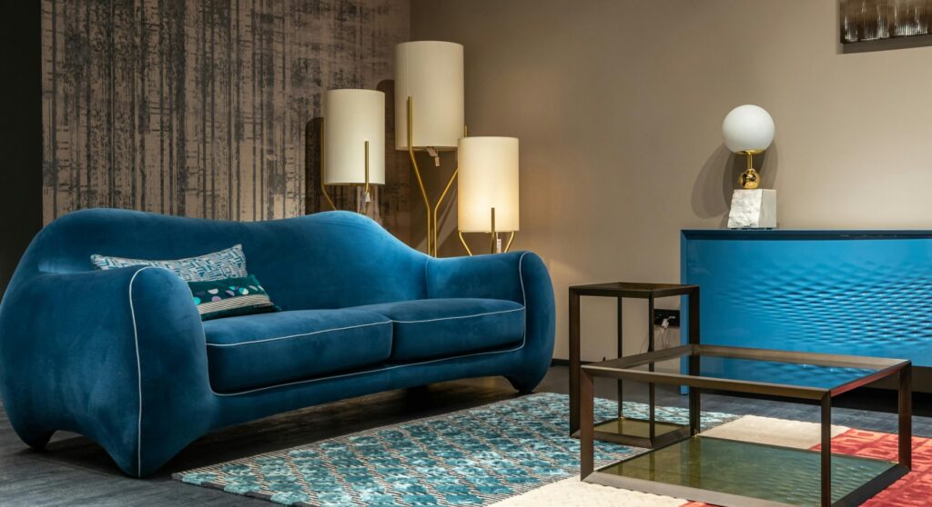 blue velvet comfy couch in a clean living room - tidybirdcleaning